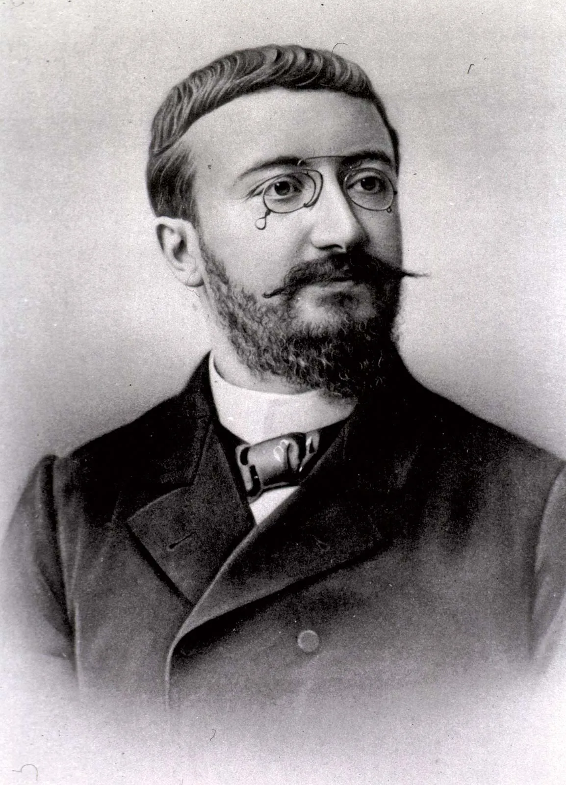 Portrait of Alfred Binet (1857–1911), French psychologist, in formal coat with pince-nez glasses.